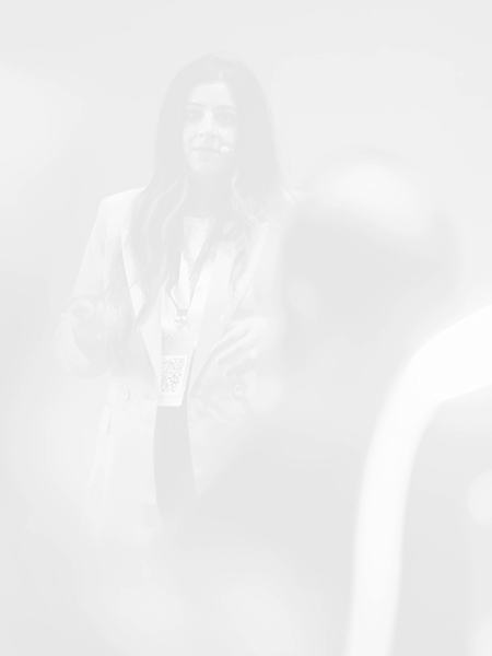 Dr Sara Mahmood is smiling while giving her talk - blurred, black and white