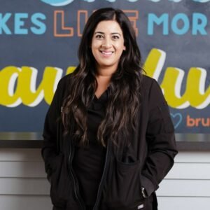 Dr Sara Mahmood is joyfully smiling at brush365