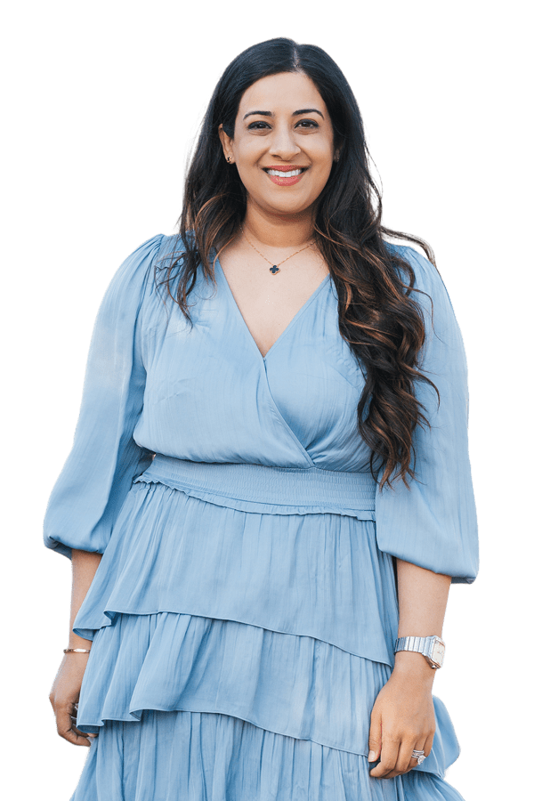 Sara Mahmood the dentist is smiling in a dress