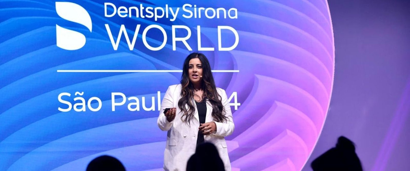 Sara Mahmood is smiling while giving her talk on stage